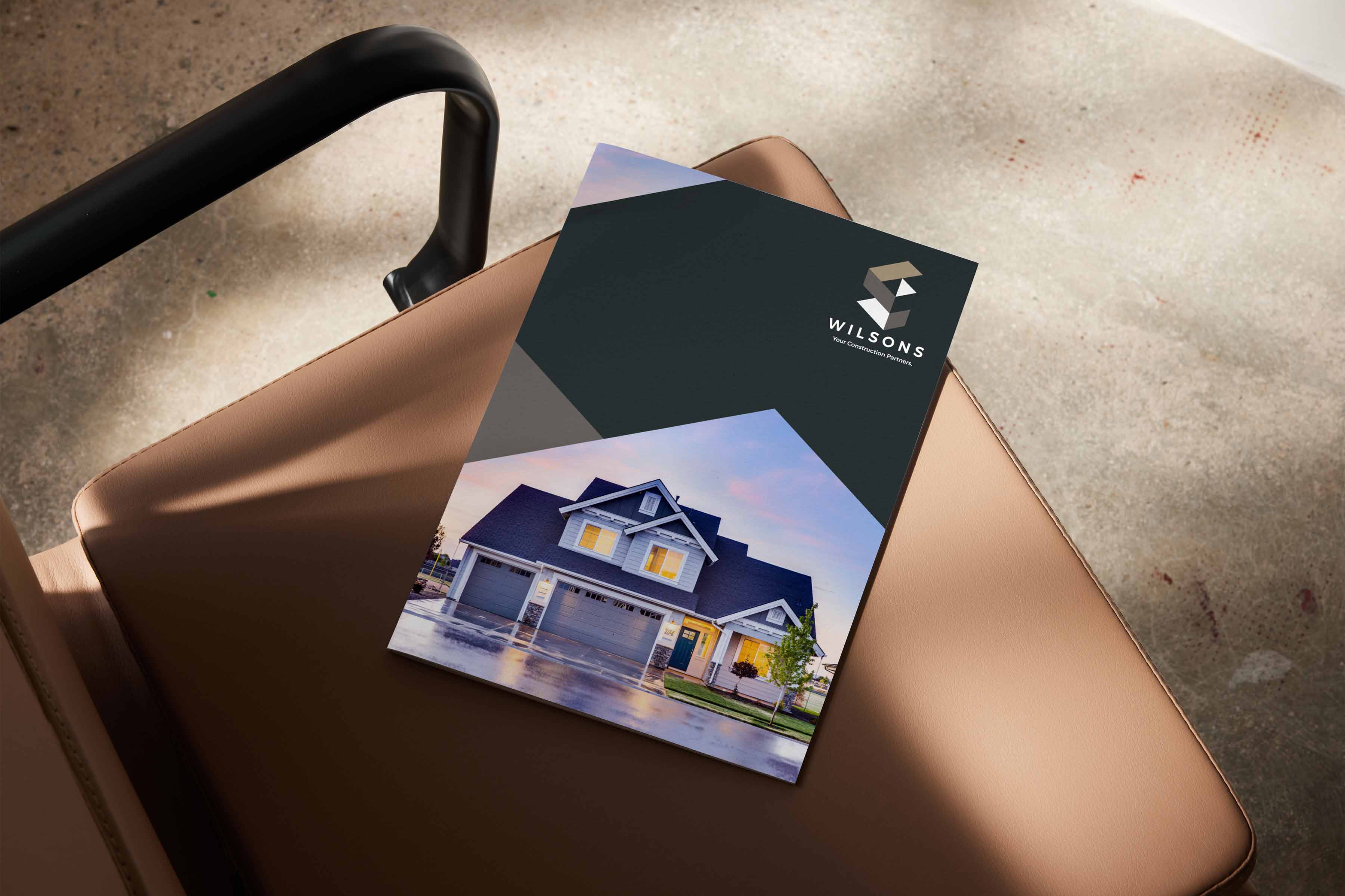 Design of a company profile for a construction company in nice lighting on a chair