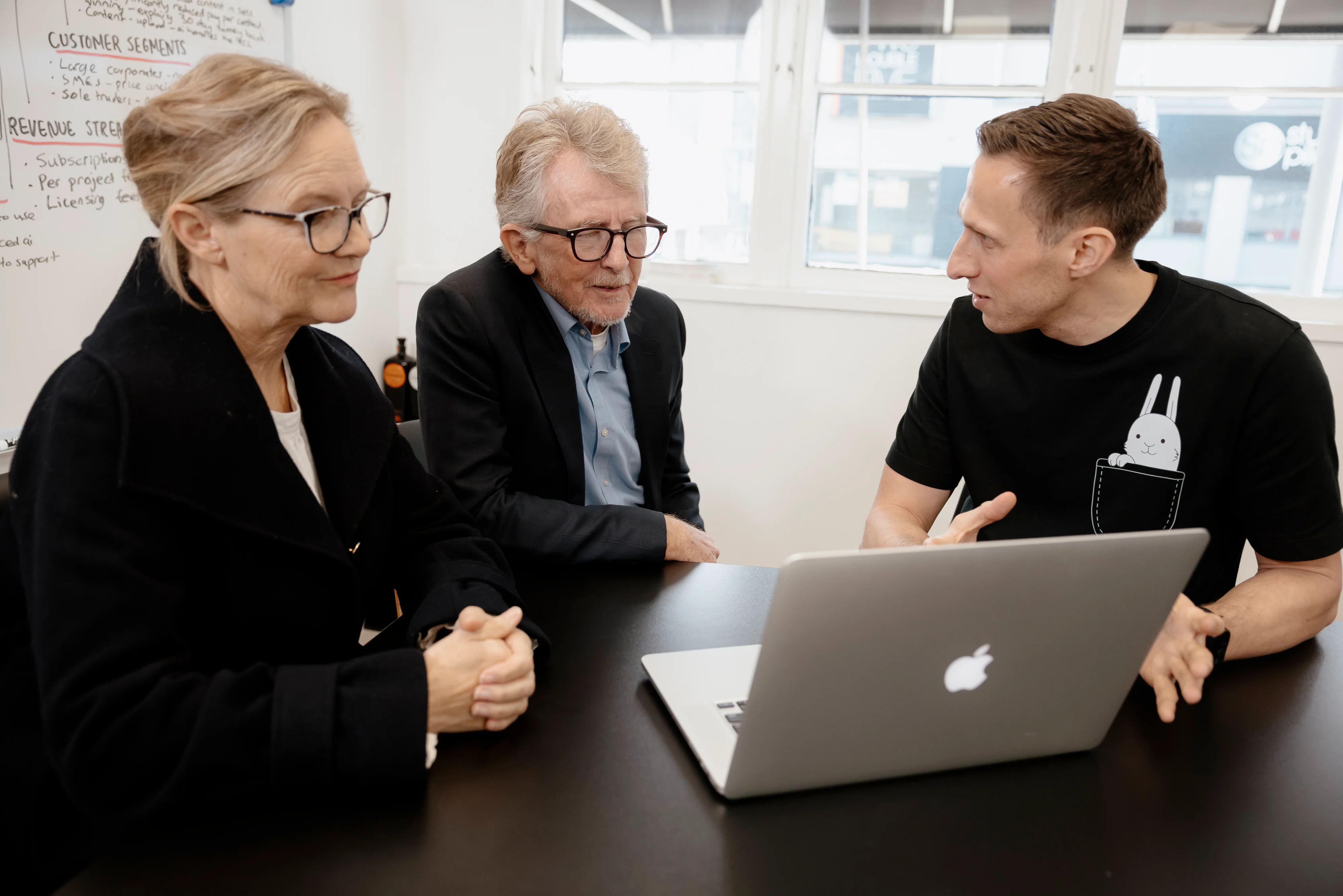 White Rabbit team discussing with clients the breakdown of graphic design costs